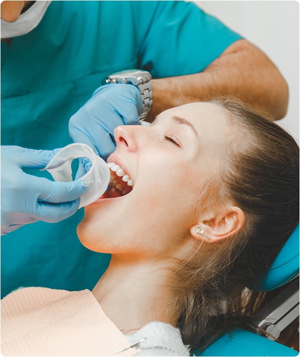 Dentista realizando procedimento em paciente